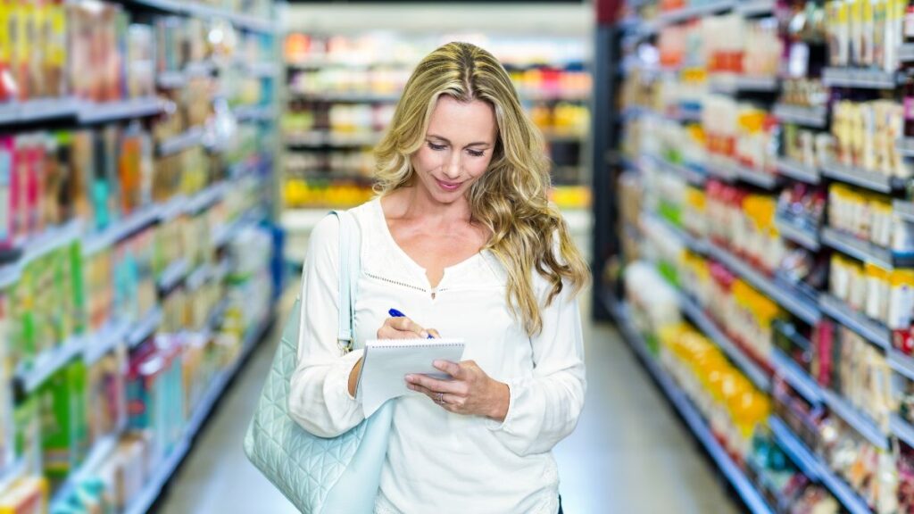 woman checking off a list at the store