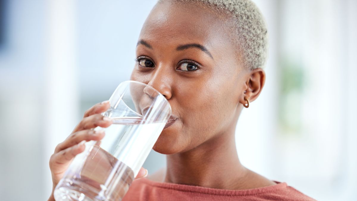 woman drinking water from a glass