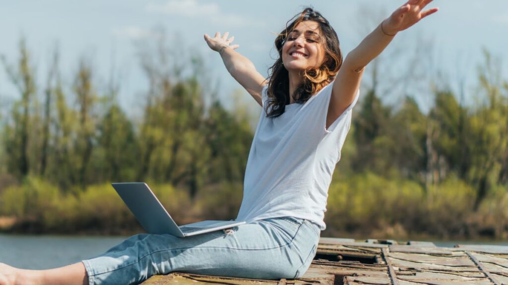 woman happy with a lap top on her lap