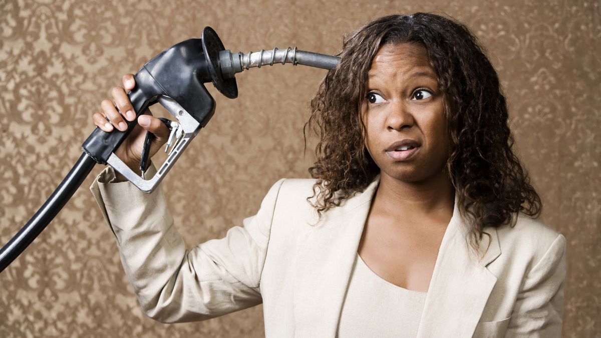 woman holding gas to head confused