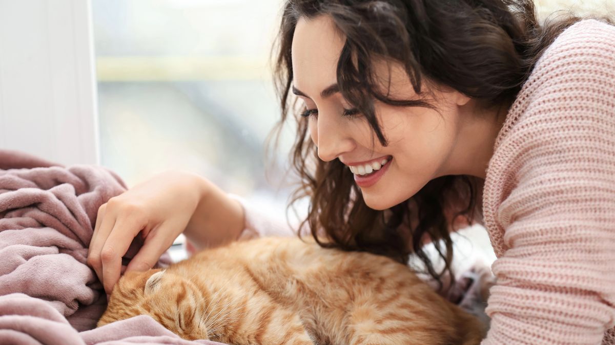 woman laying with cat