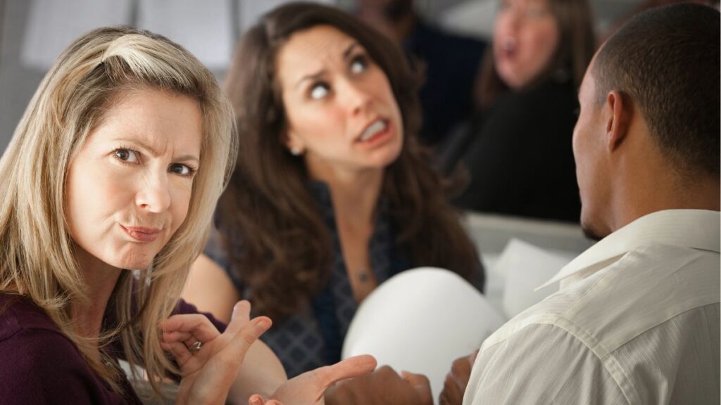 woman looking annoyed at another woman