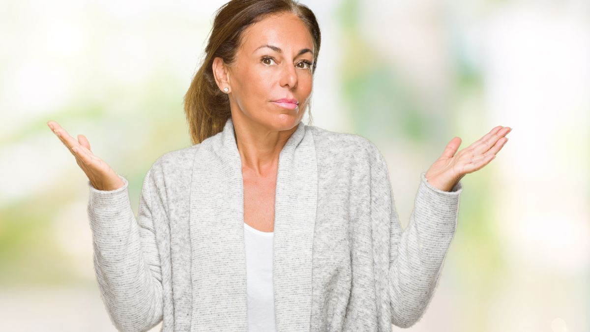 woman looking annoyed with hands up