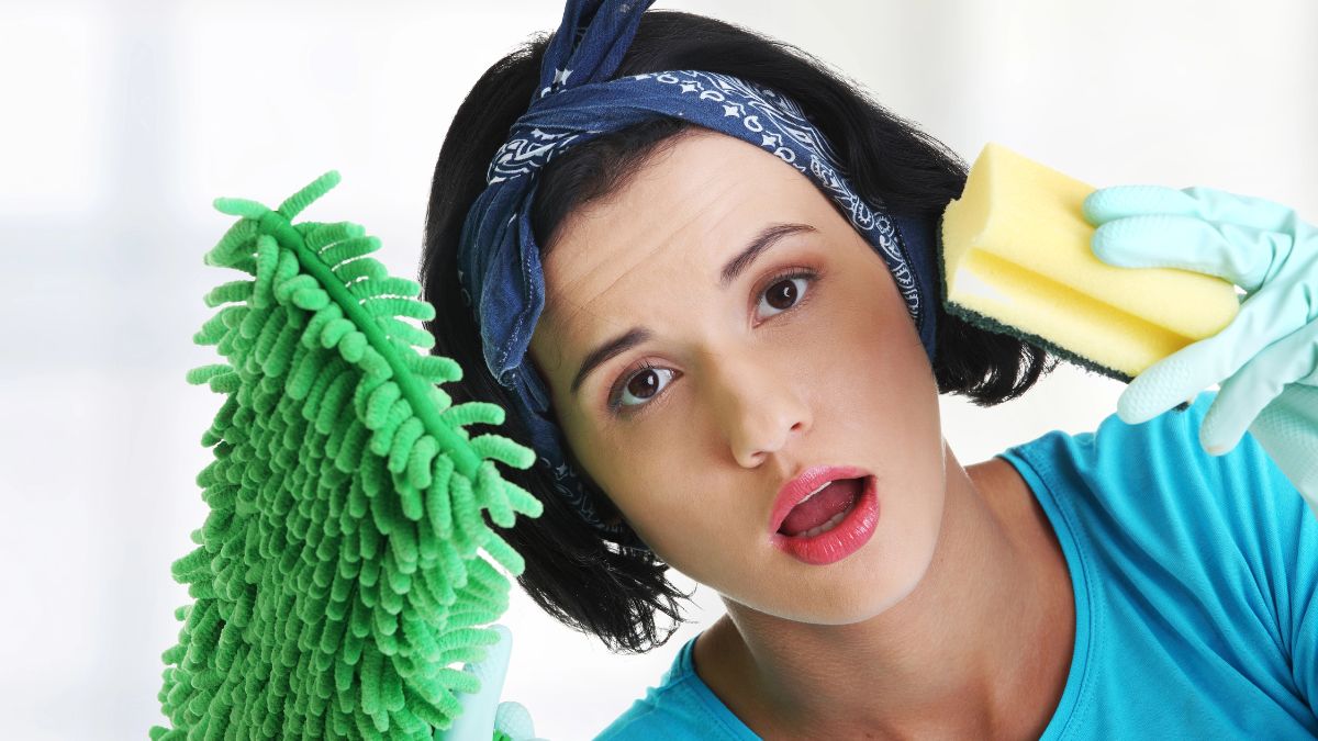 woman looking confused with cleaning supplies