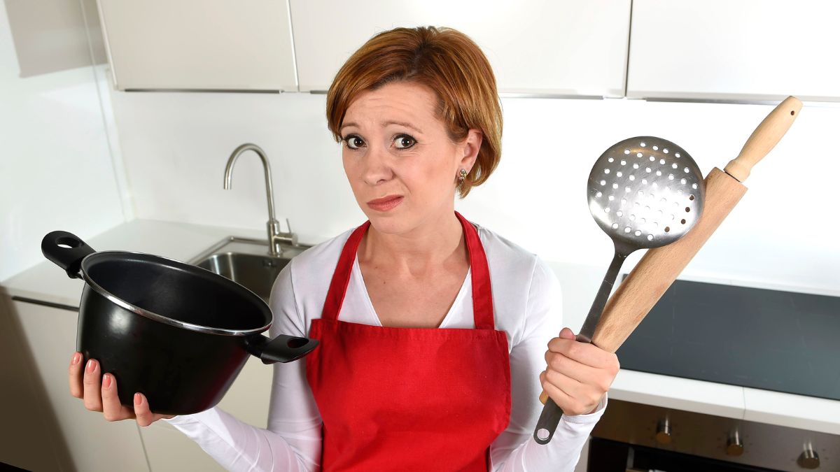 woman looking confused with kitchen items