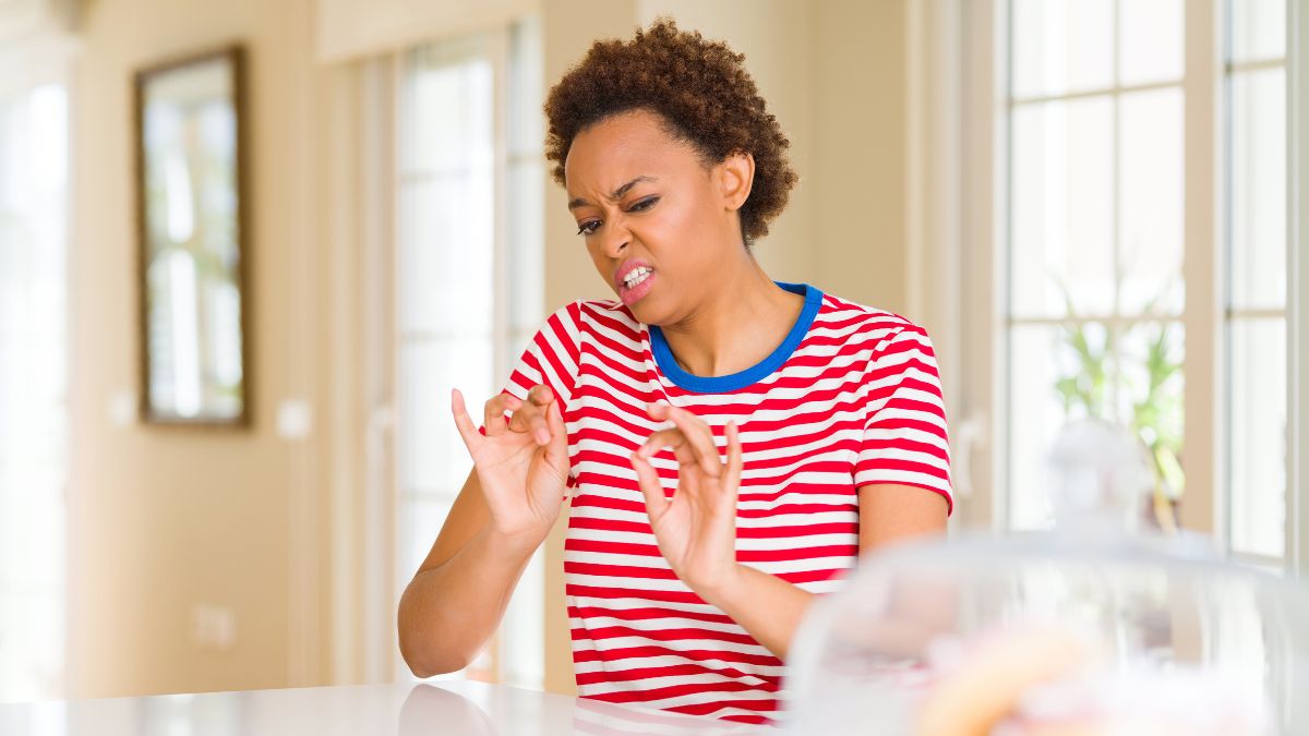 woman looking disgusted in kitchen