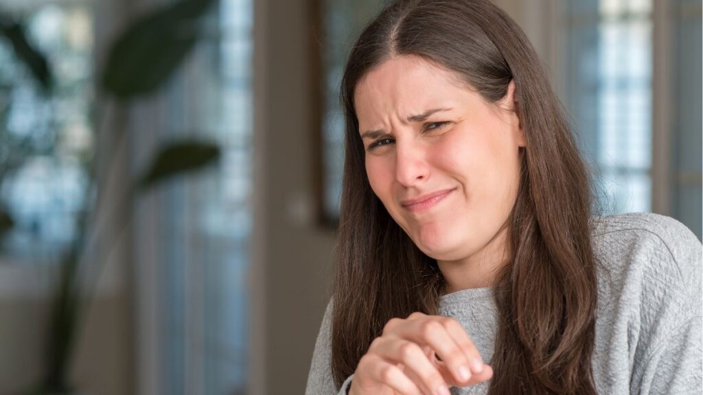 woman looking grossed out