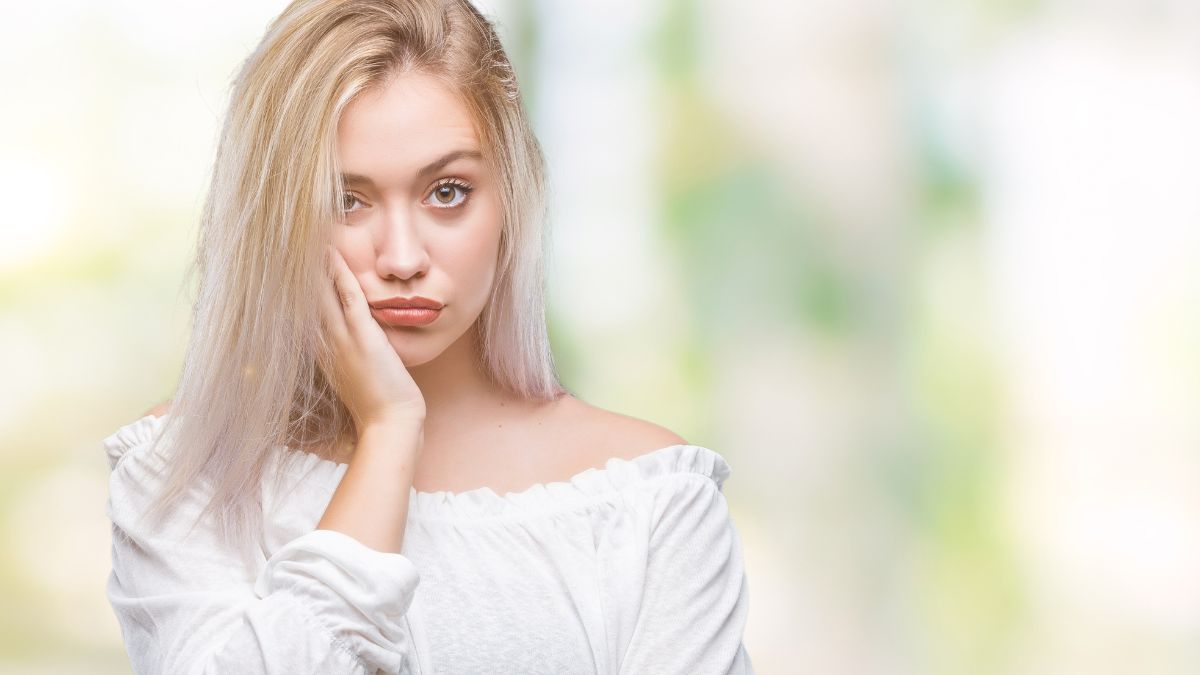 woman looking judgy with hand on face