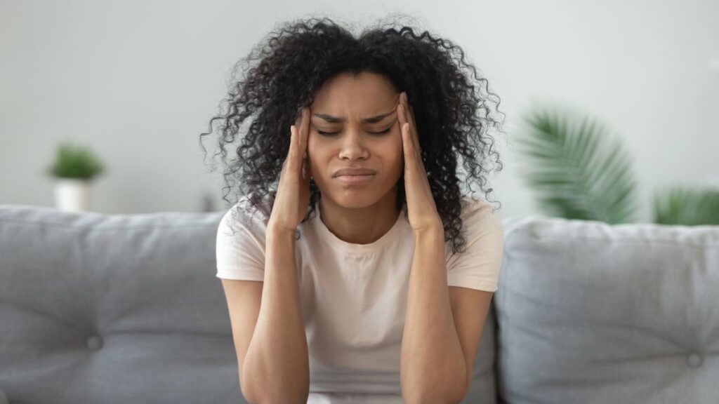 woman looking stressed with hands on head