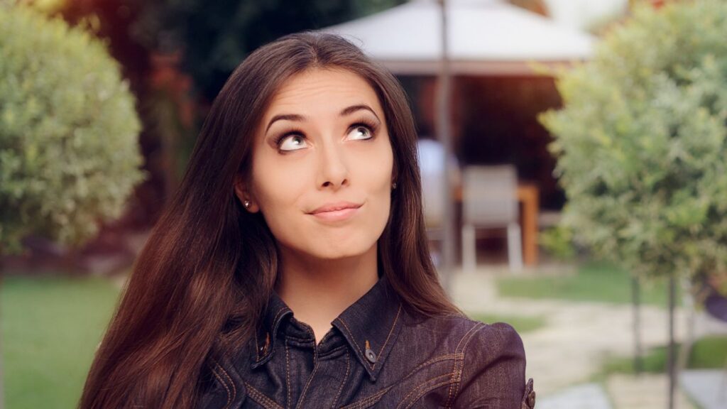 woman looking up rolling her eyes outide