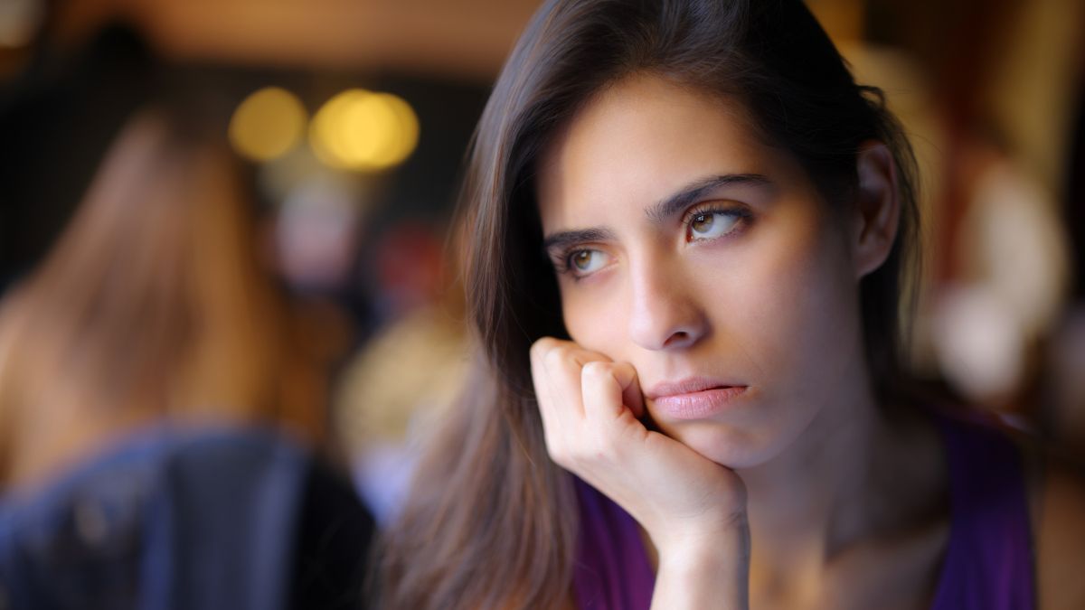 woman looking upset with hand on face