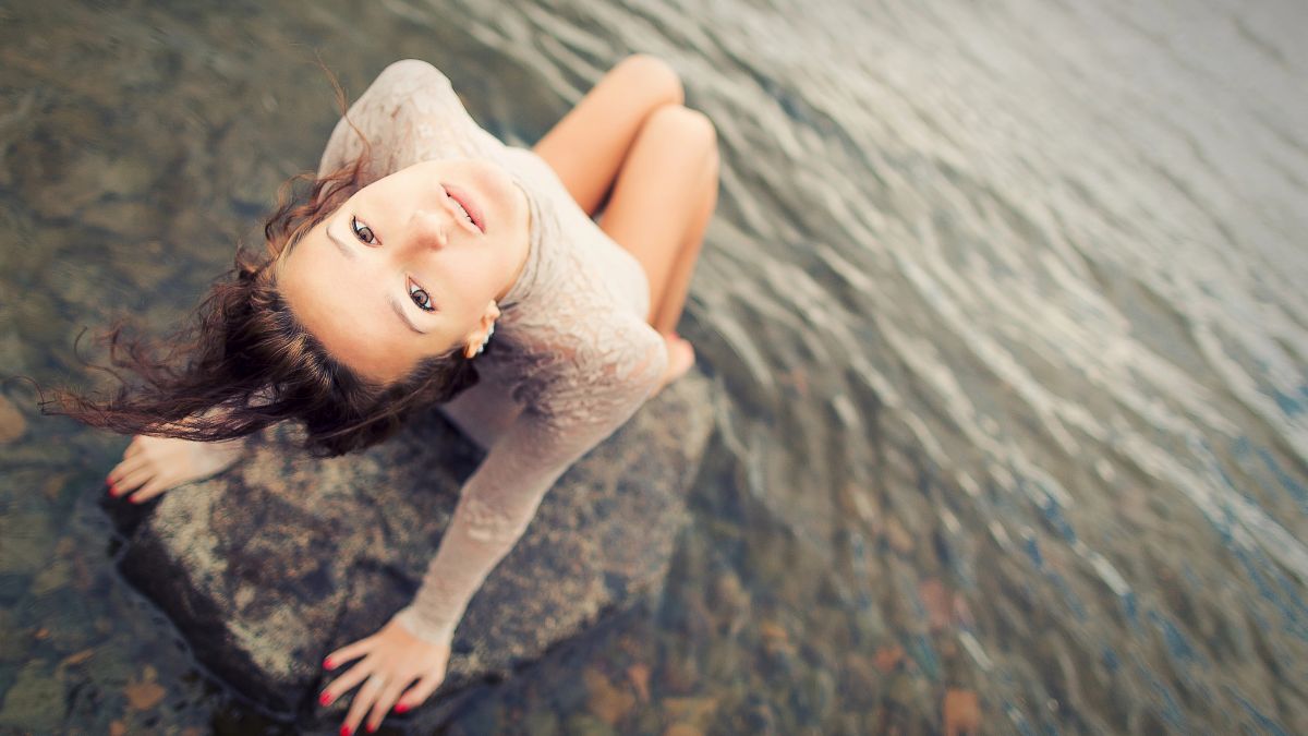 woman sitting on a rock