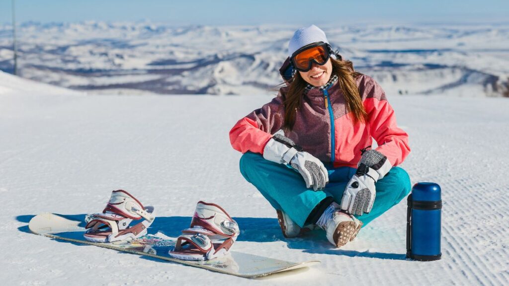 woman smiling on a snowy cliff