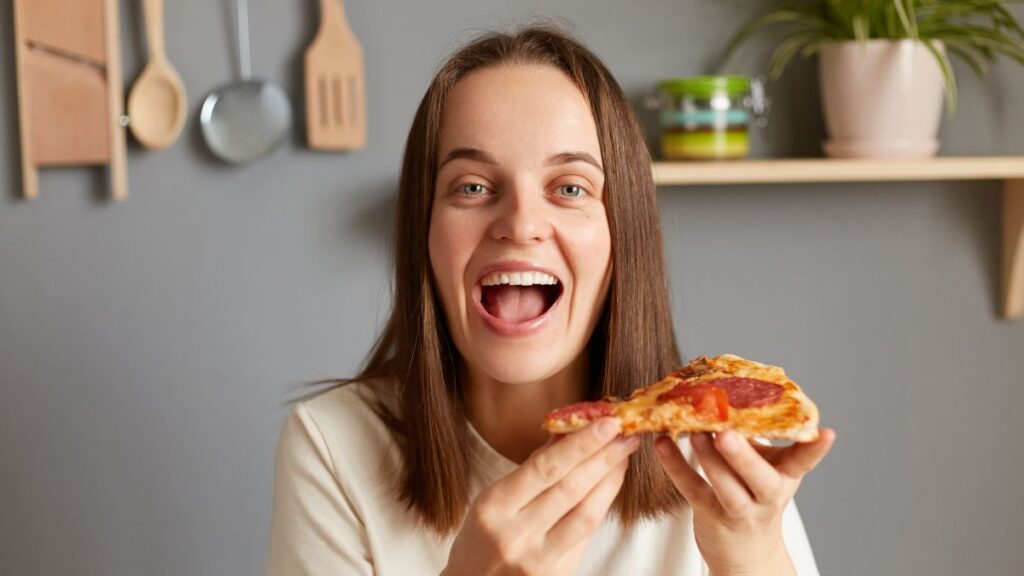 woman smiling with pizza