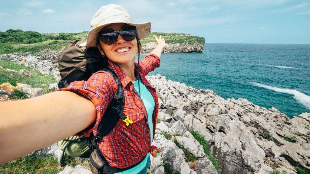 woman taking selfie traveling alone