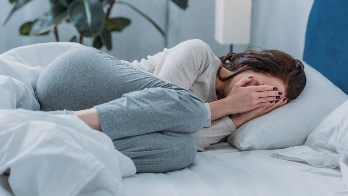 woman upset in bed faced covered