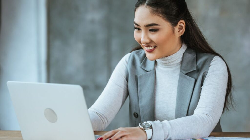 woman working at computer smiling