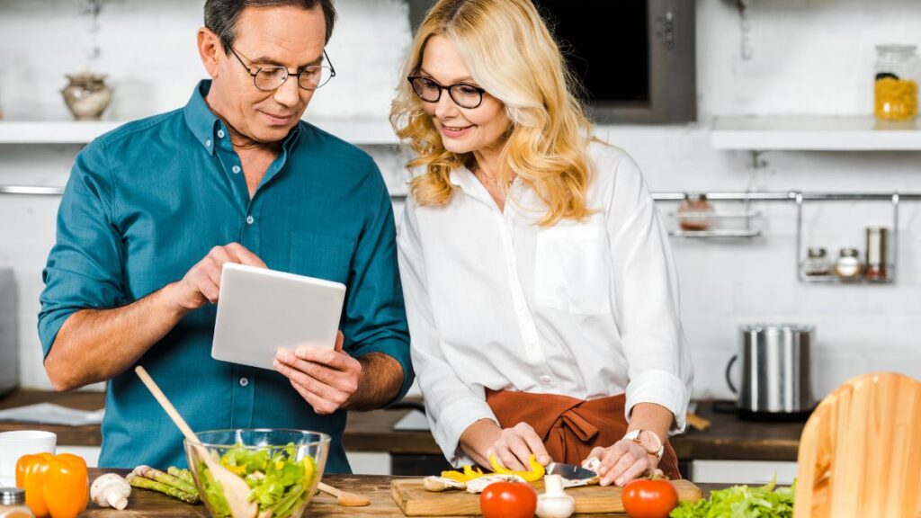 Older couple in the kitchen cooking