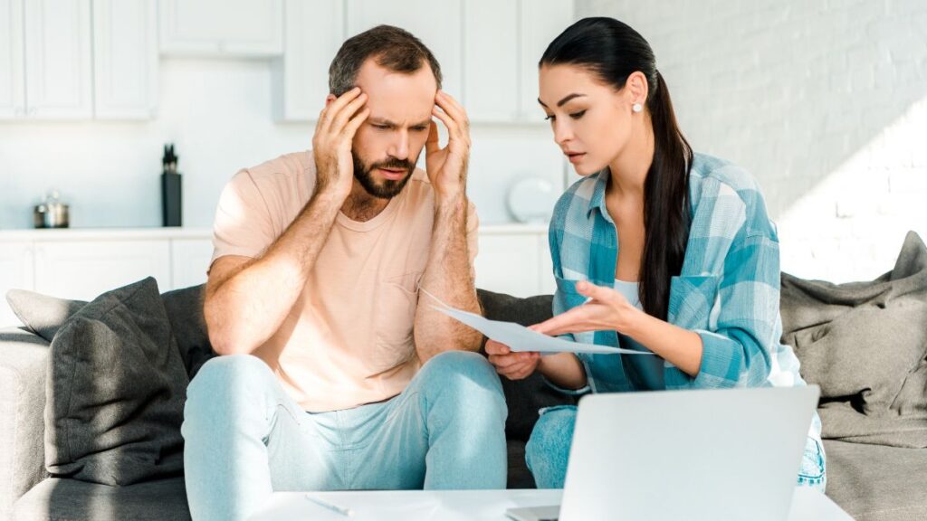 couple looking at bills stressed