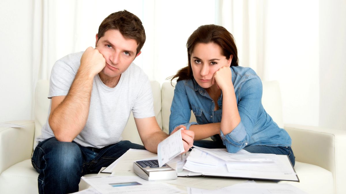 couple looking stressed with bills