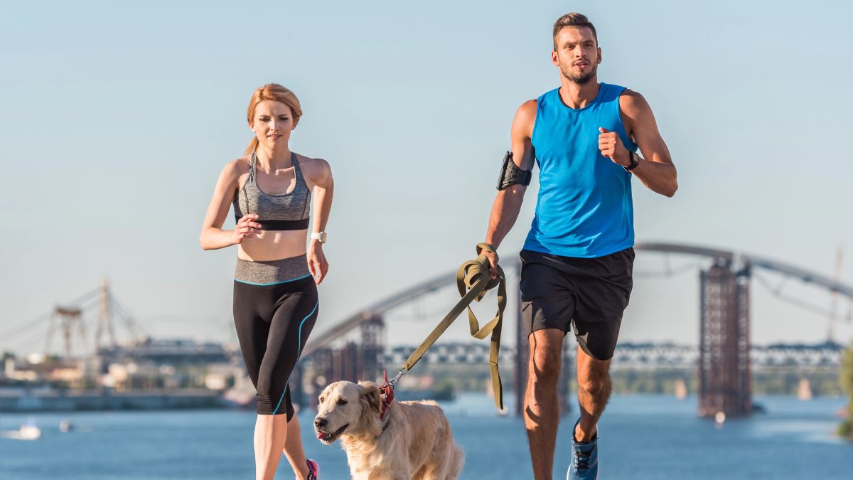 couple running with dog