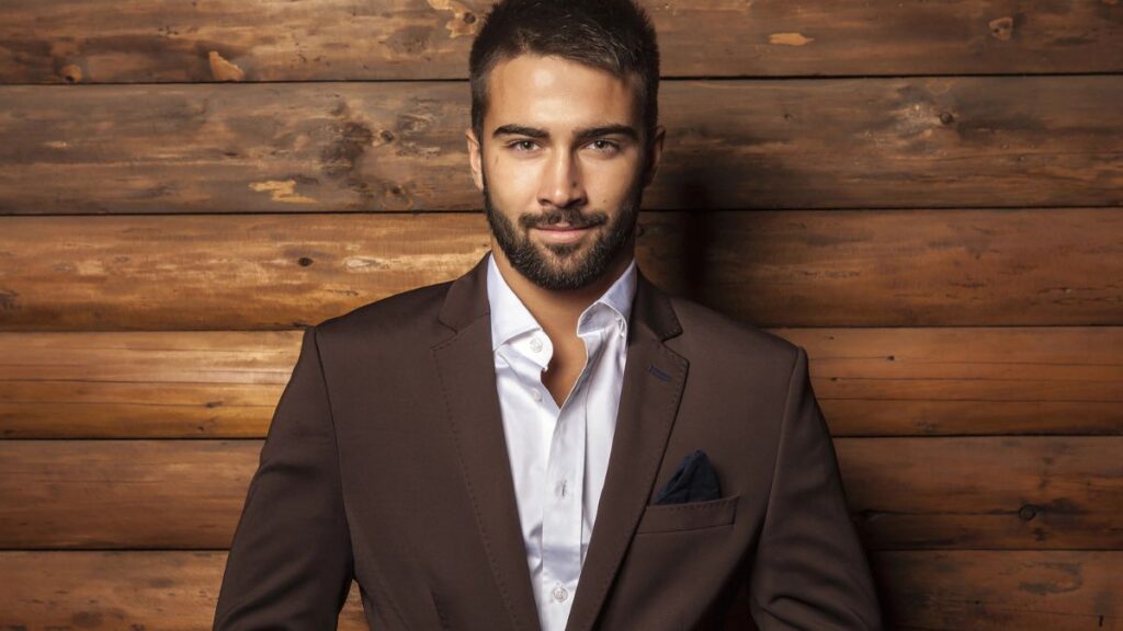 handsome man smiling in brown suit