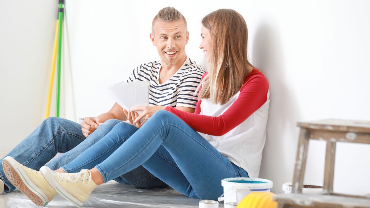 happy couple sitting and talking about updating their home