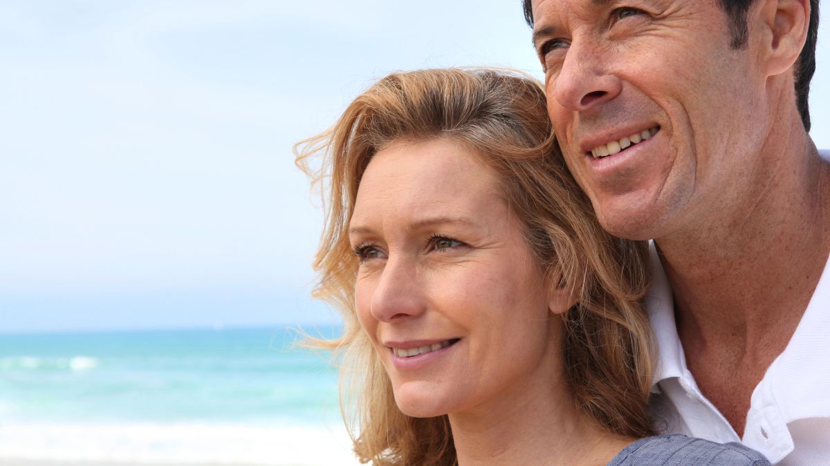 happy couple standing on the beach