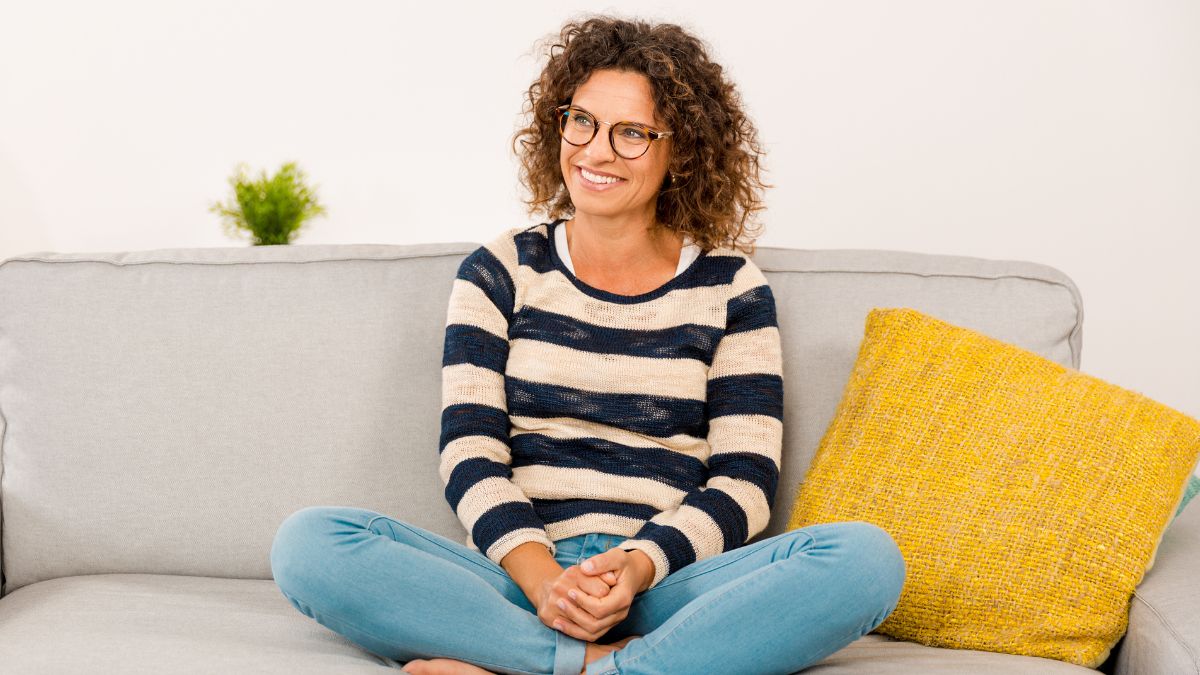 happy woman sitting on couch