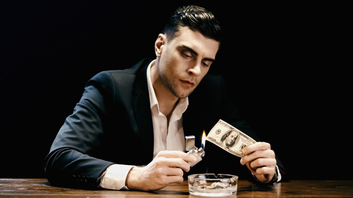 man burning money