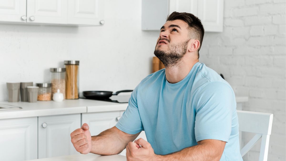 man looking irritated at the table