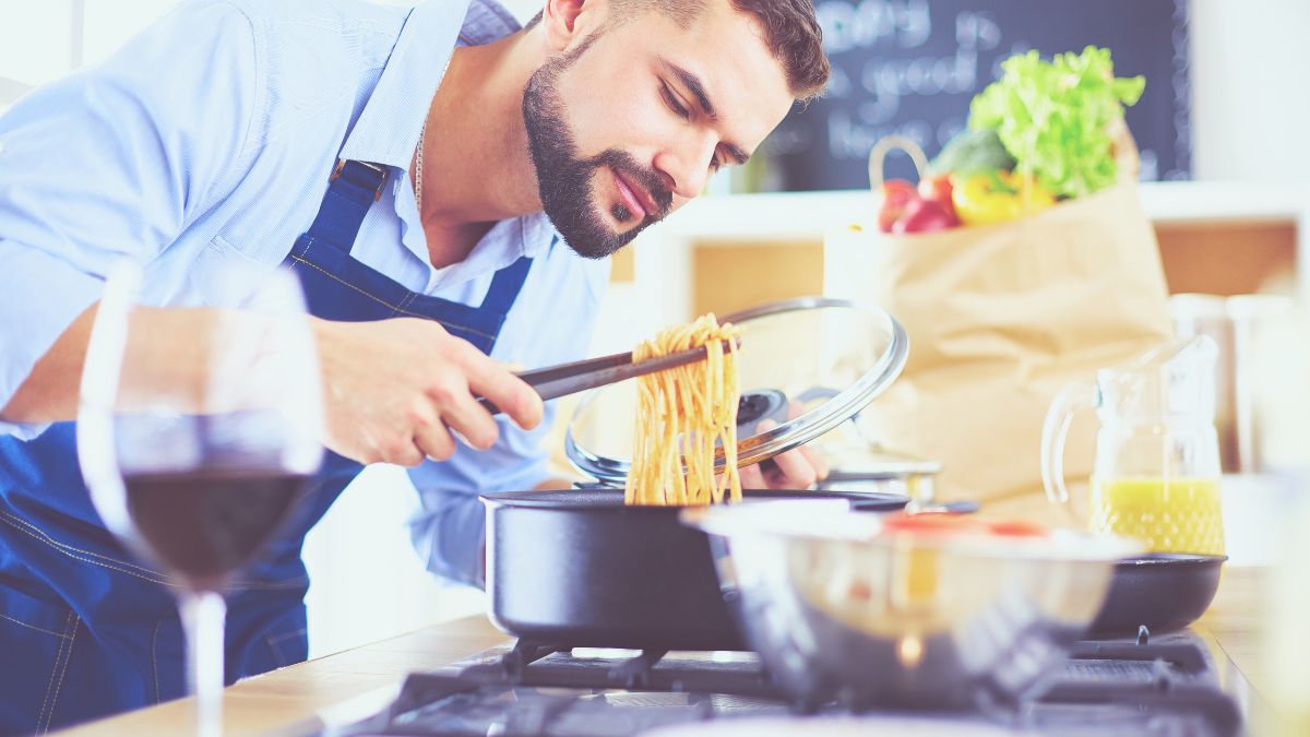 man making pasta in kitchen