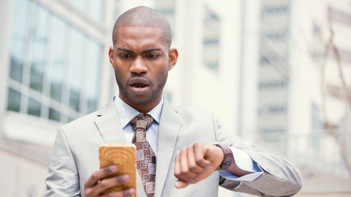 man running late looking at phone