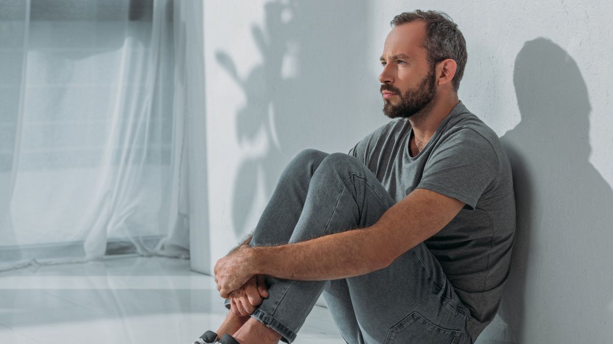 man sitting and looking stressed