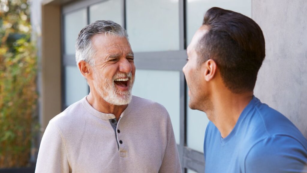 older and younger man laughing