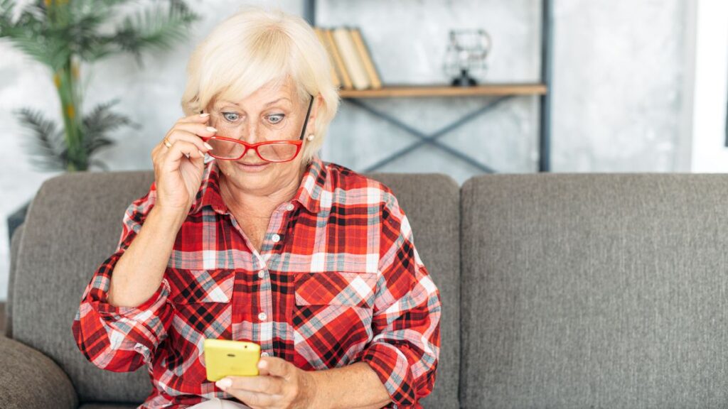 older woman confused looking at phone