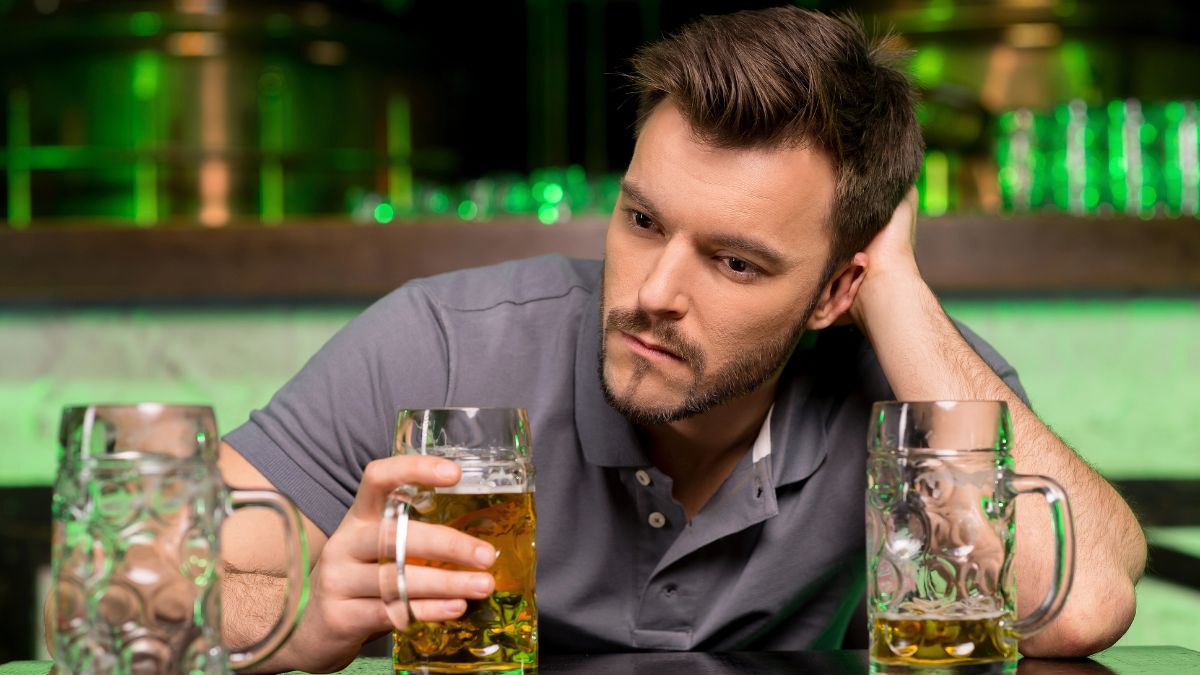 sad man at bar with drinks