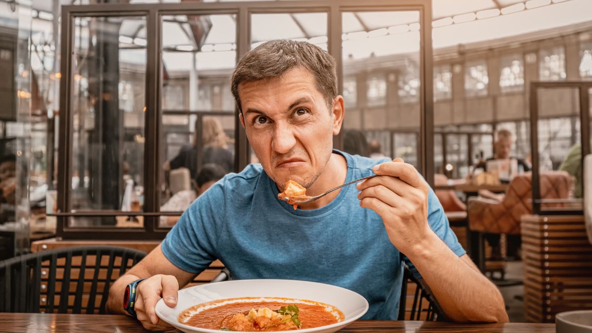 unhappy man sitting with soup