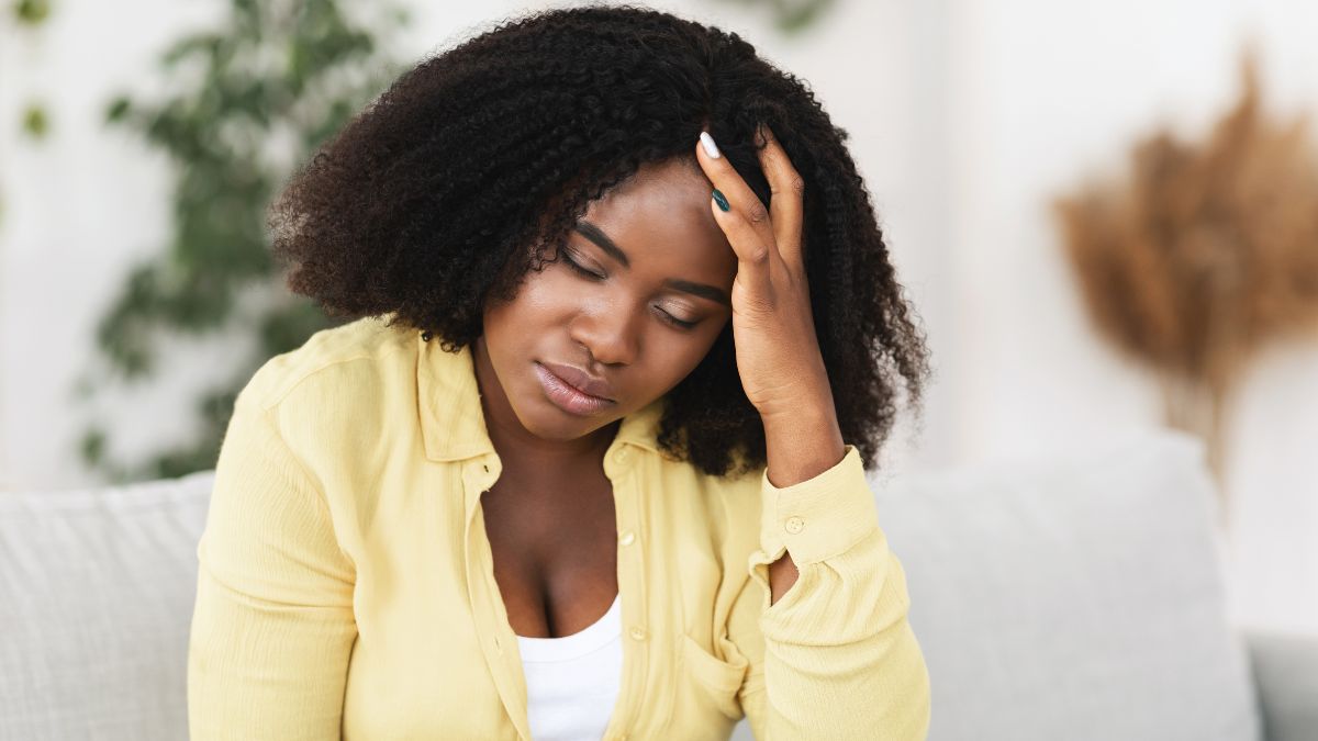 woman on couch looking upset