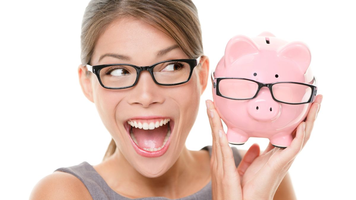 woman smiling with piggy bank