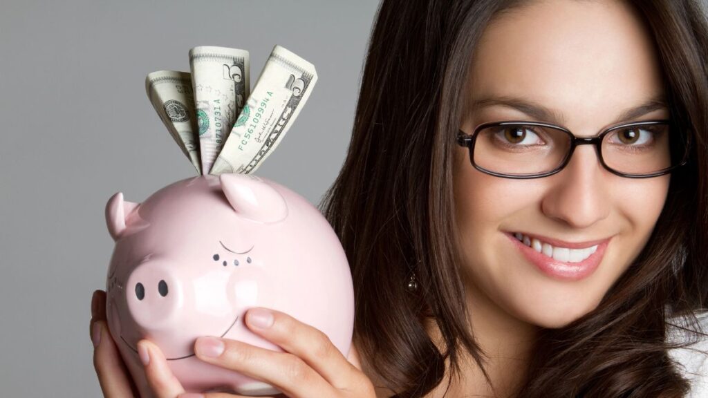 woman smiling with piggy bank