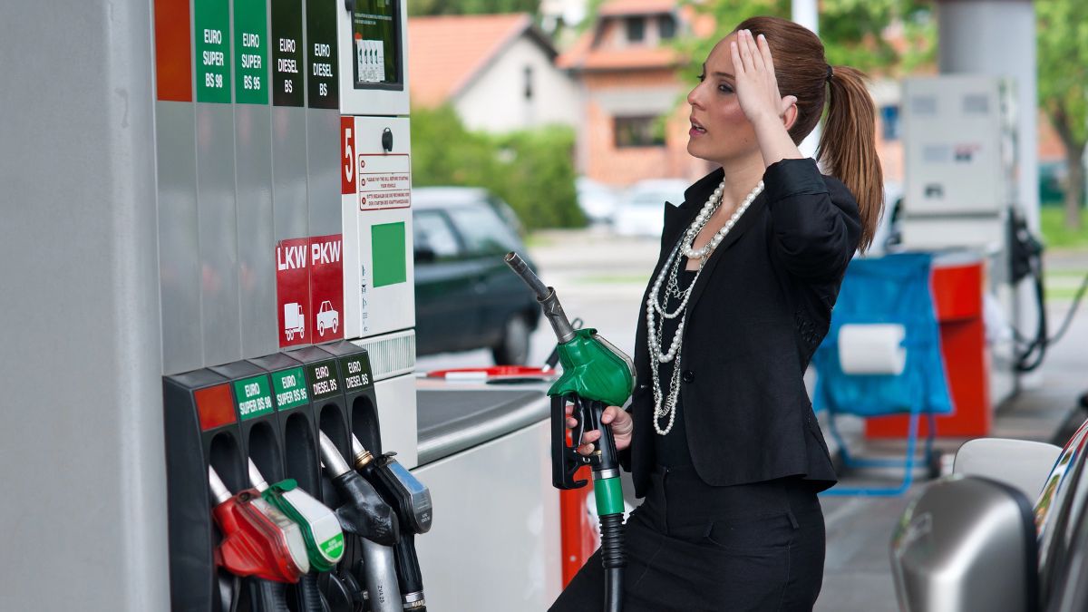 woman upset pumping gas