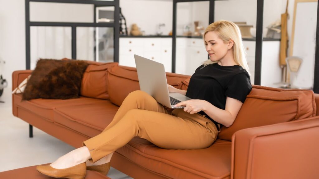 woman with computer sitting on couch