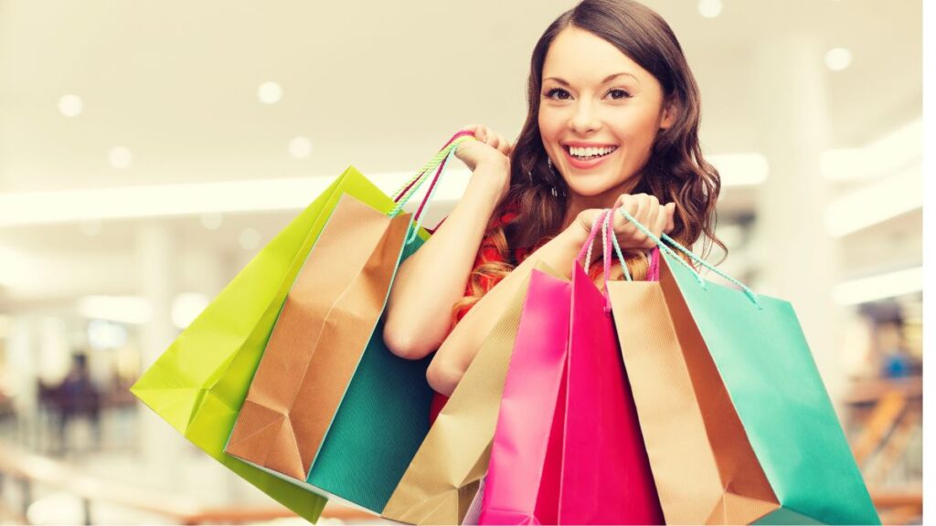 woman with shopping bags smiling