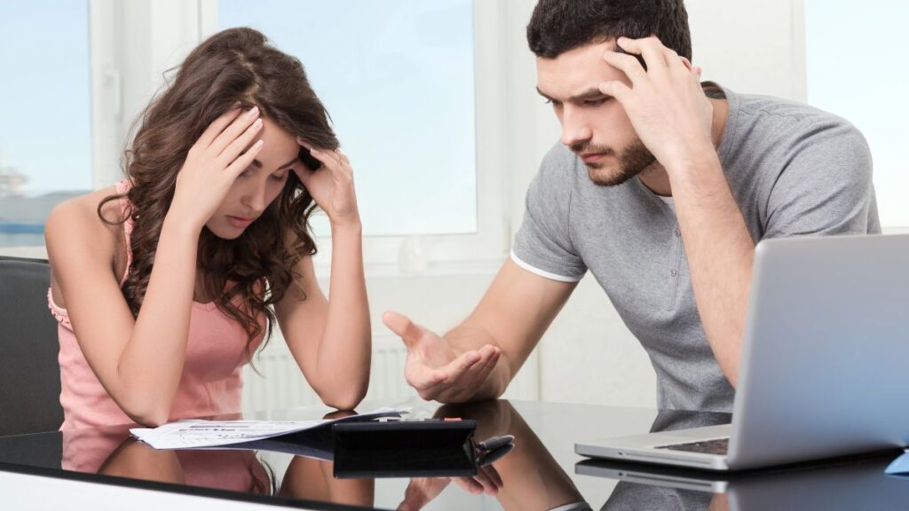 couple at the table stressed over bills