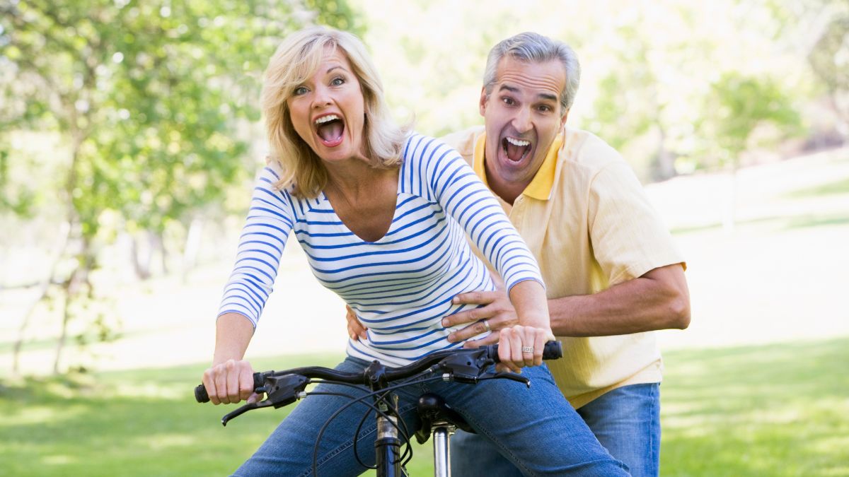 couple on a bike being silly