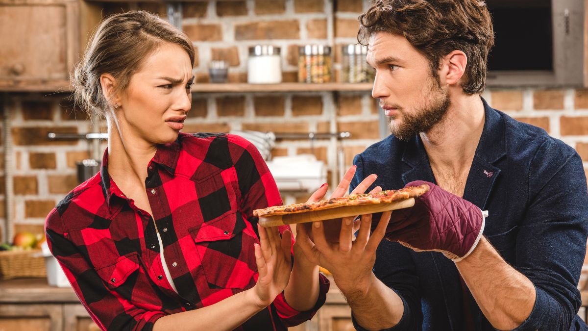 couple with pizza woman looking disgusted