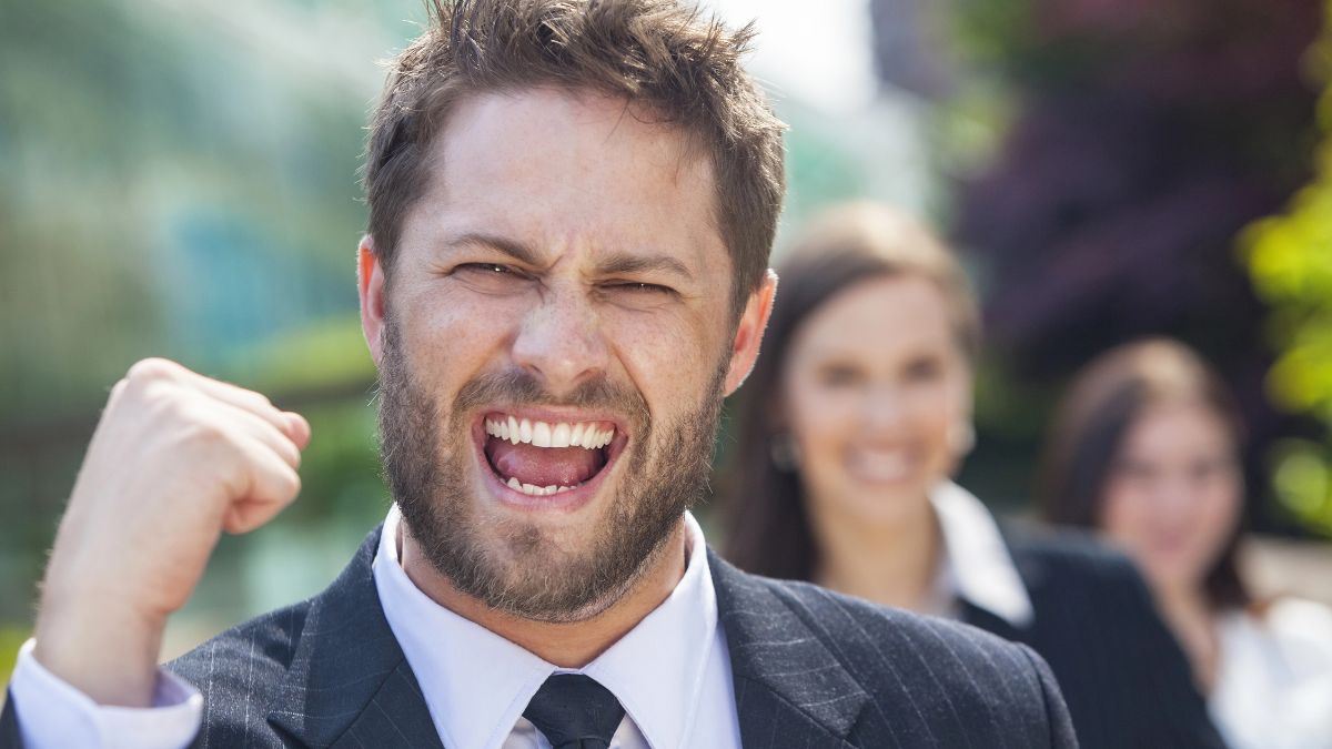 excited man smiling with fist up