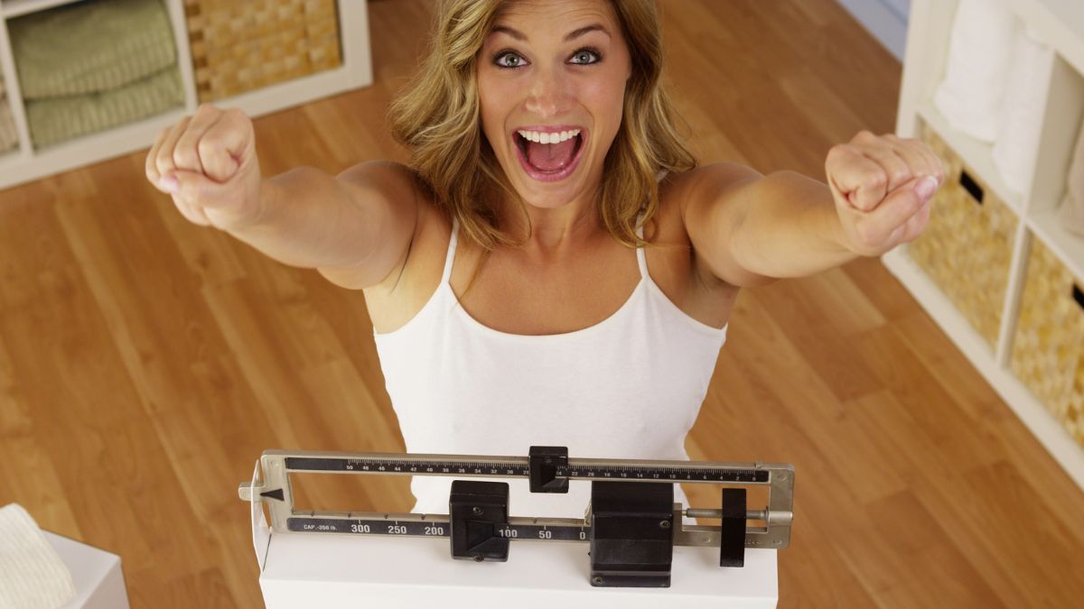 happy woman on the scale