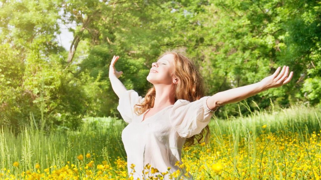 happy woman sitting in the grass